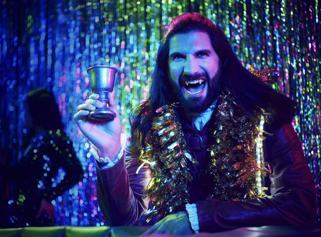 Image from the series What We Do in the Shadows of vampire holding cup. 